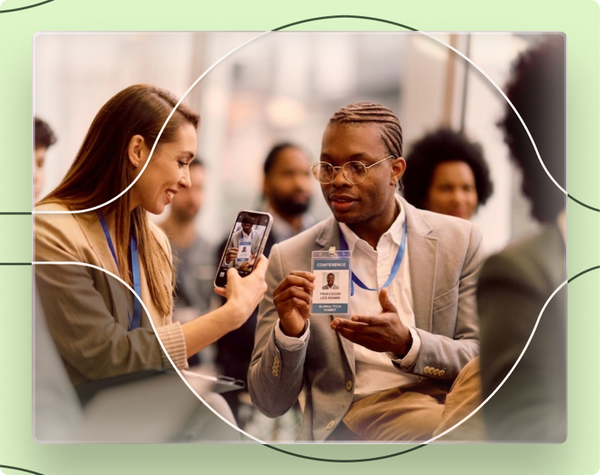 Two people interacting with a smartphone at an event, with a green border.