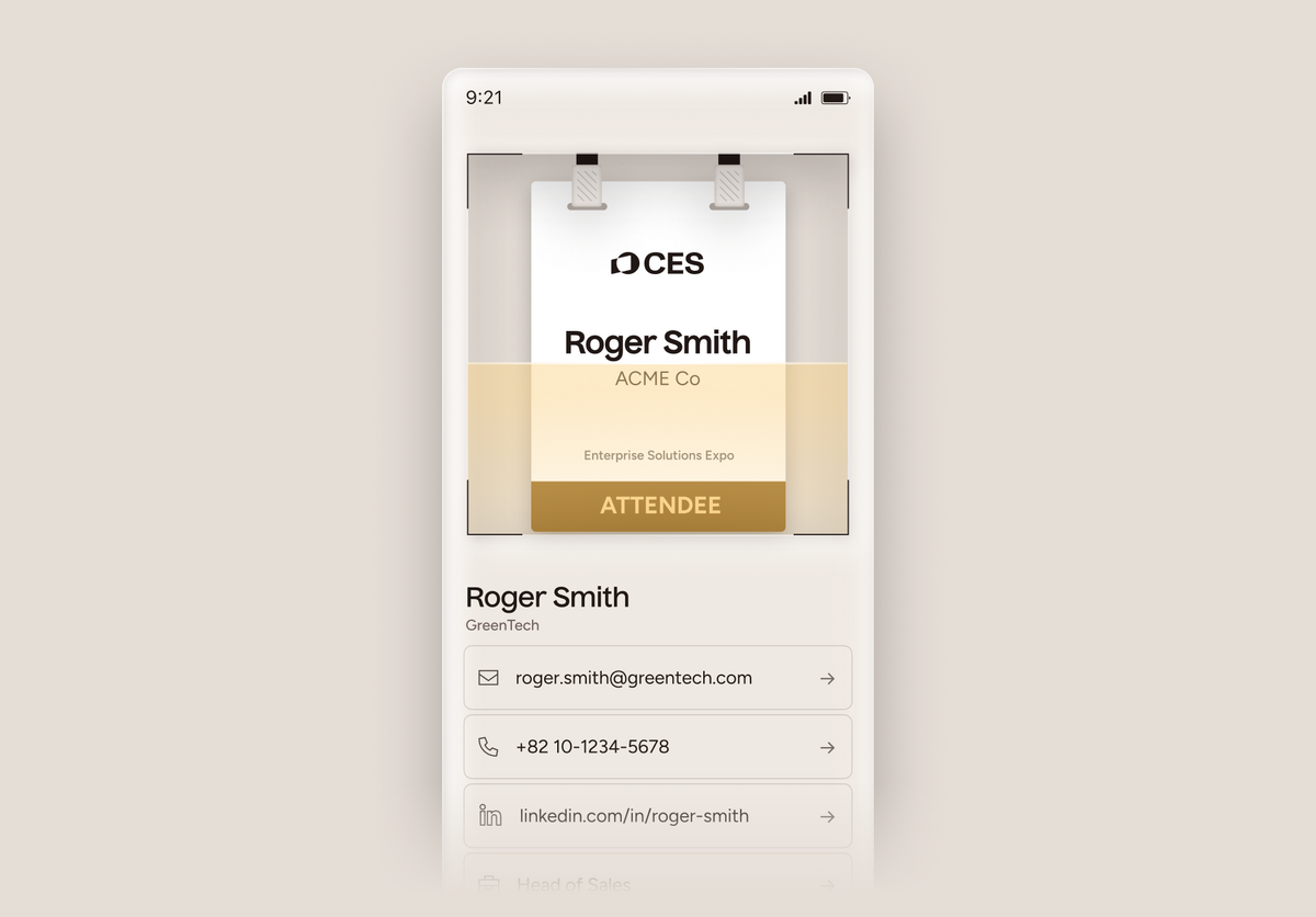 A digital mockup of a mobile phone displaying an attendee pass interface for CES 2025, featuring a white and gold digital pass for Roger Smith from ACME Co, set against a light beige background.